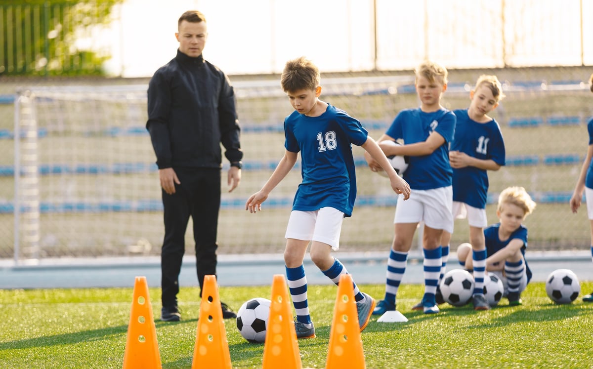Group of Young Boys on Football Training with Soccer Coach