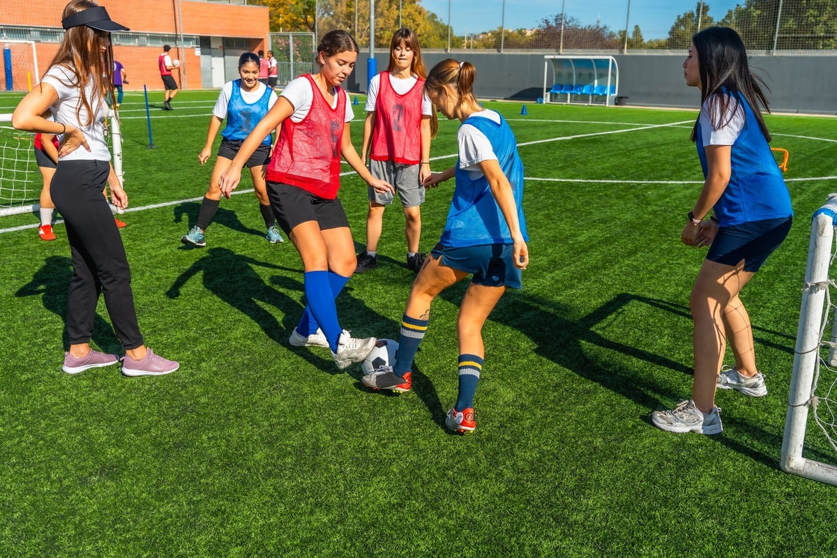 Teenagers participating in a girls soccer training session